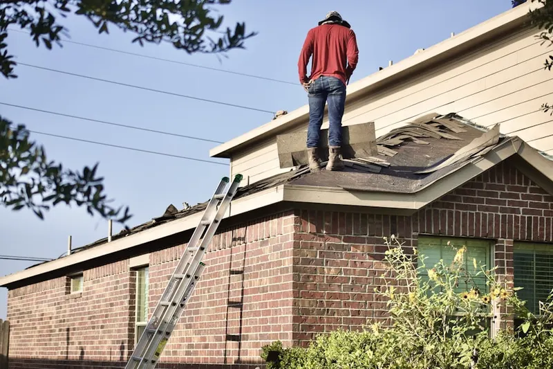Professional roofer working on a residential roof in Panorama Estates